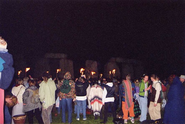 The crowd watches as the drummers process around the circle, with the Stones dimly visible, ghost-stones, behind the torches. However to the human eye rather than the camera, the stones could be clearly seen.